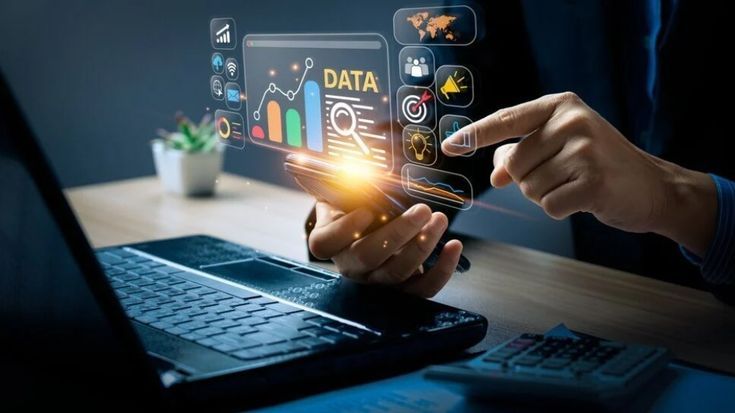 A business professional using a smartphone and laptop with holographic data charts and icons, representing website analytics, user insights, and conversion tools.
