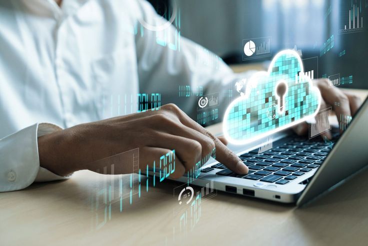 Person typing on a laptop with a digital cloud and data security icons, symbolizing cloud computing and AI-powered cloud technology.