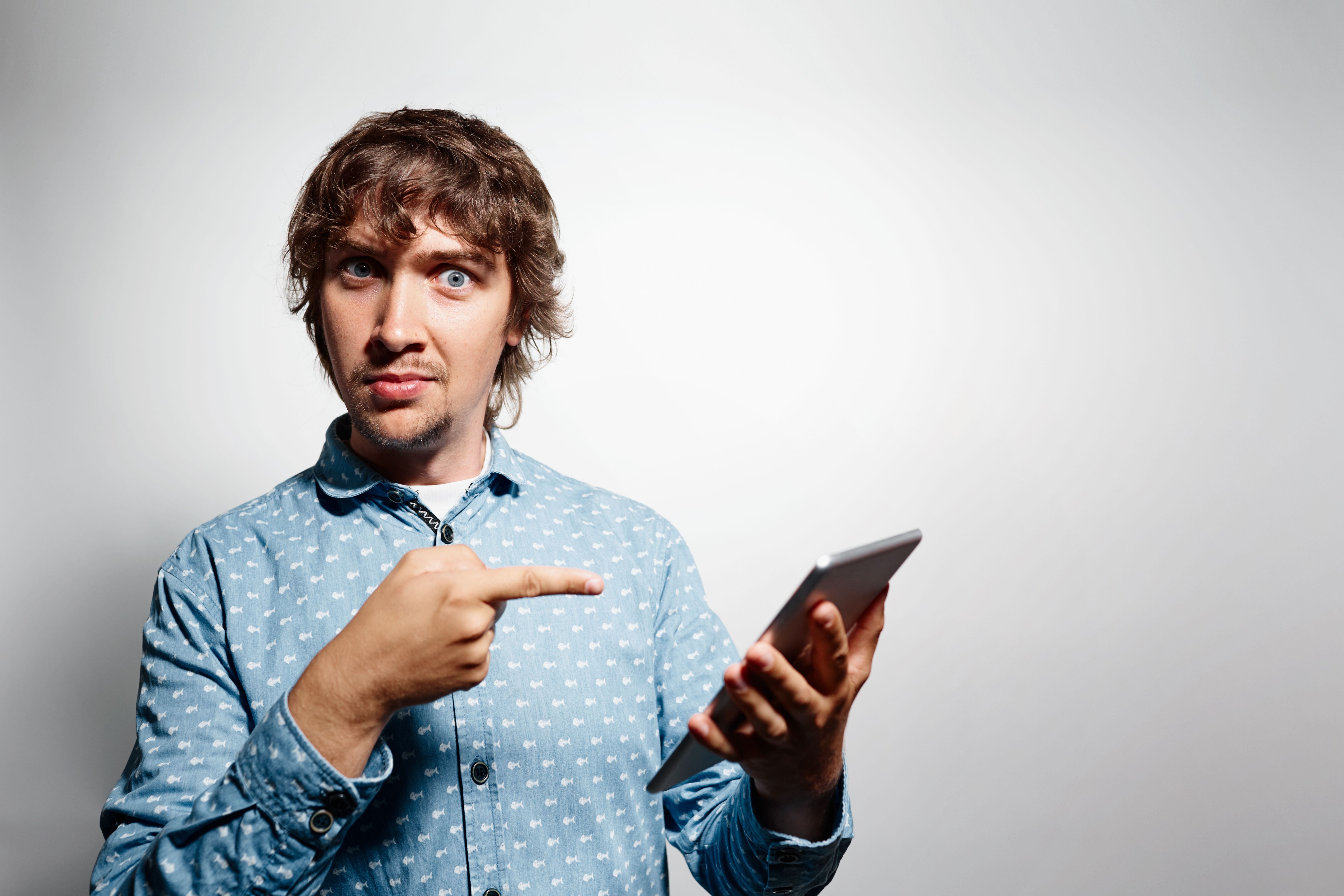 young-man-wearing-blue-shirt-holding-tablet.jpg